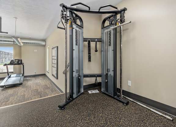 A gym with a treadmill, a weight machine and a treadmill.