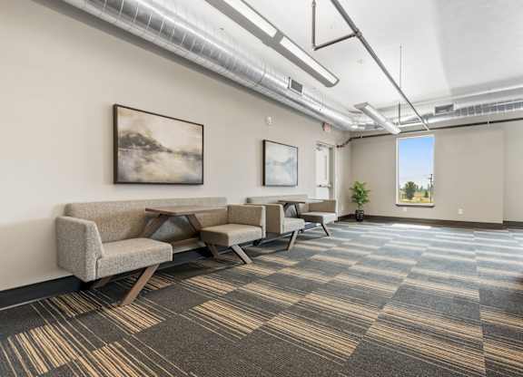 A room with a carpeted floor and a couch.