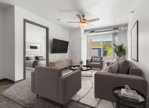 A living room with a brown couch, a grey couch, a coffee table, and a television.