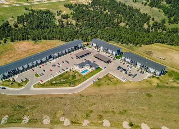 an aerial view of a parking lot and a building