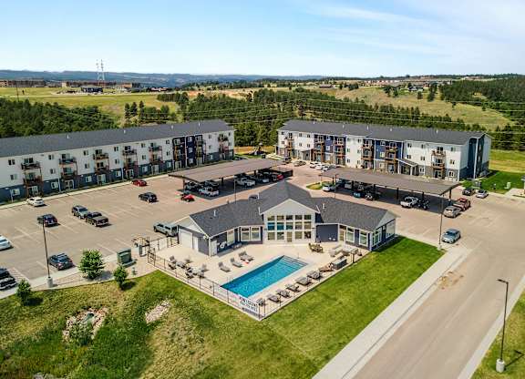 an aerial view of an apartment building with a swimming pool