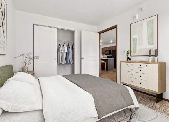 A bedroom with a bed, dresser, and mirror.