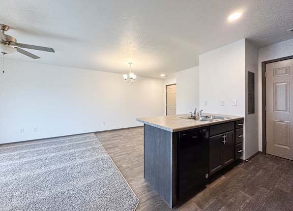 A kitchen with a sink and a fan.