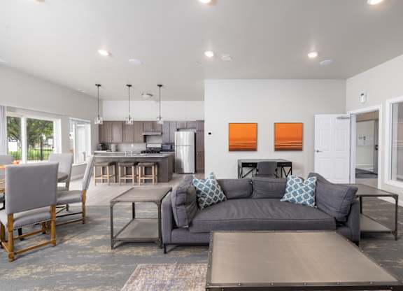 A modern living room with a grey couch and a wooden coffee table.
