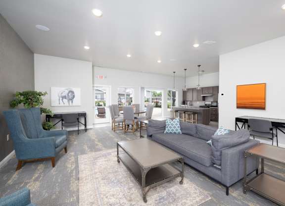 A living room with a grey couch and a blue chair.