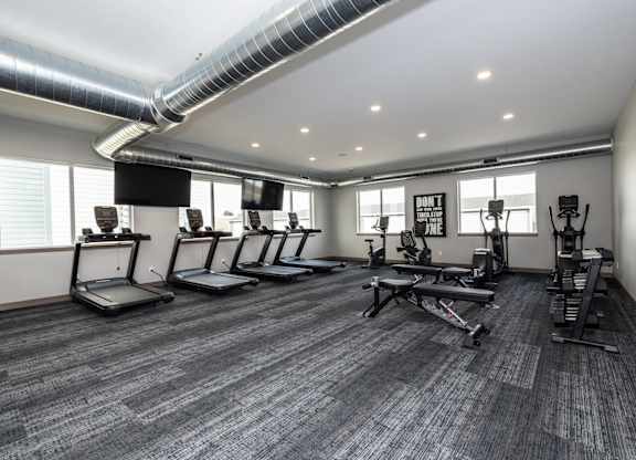 A gym with treadmills and exercise equipment.