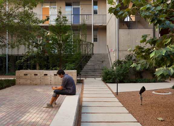 Courtyard with walking path and resident seating at 1221 Broadway Lofts Apartments, Texas, 78215
