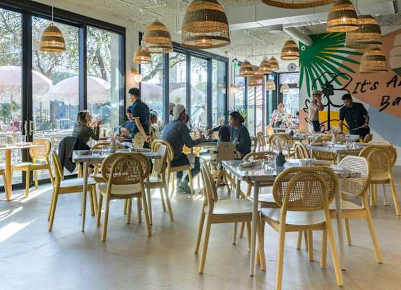 Community dining area with natural light at THE'68 Apartments, San Antonio