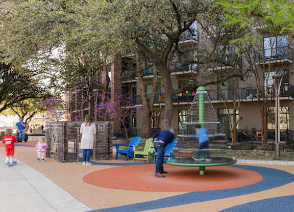 Community playground and outdoor seating area at THE'68 Apartments, Texas, 78205