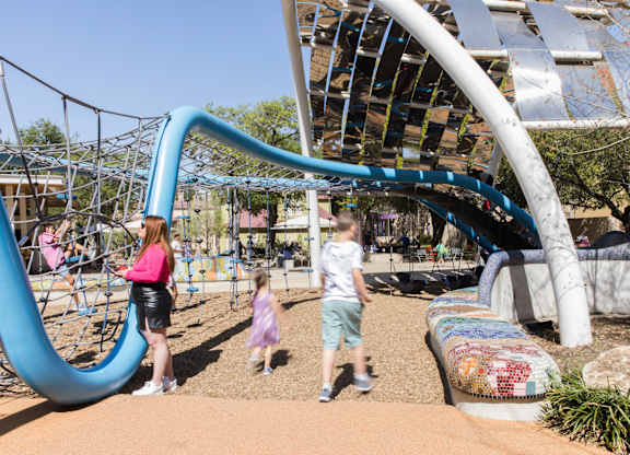 Playground with climbing structures and slides at THE'68 Apartments, San Antonio, TX