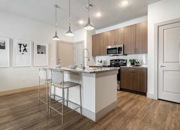 Kitchen with white island at McCarty Commons, San Marcos