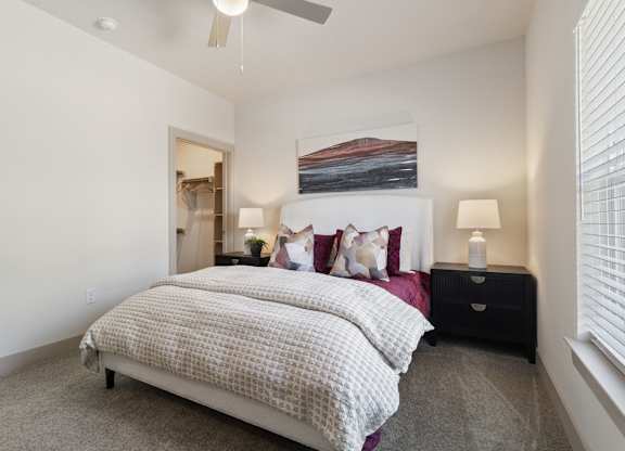 Bedroom with bed and comforter at McCarty Commons, San Marcos, TX