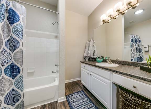 a bathroom with a shower sink and mirror at Sunrise Canyon, Universal City, TX, 78148