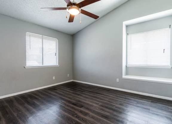 an empty living room with a ceiling fan and a window at Northchase,Texas