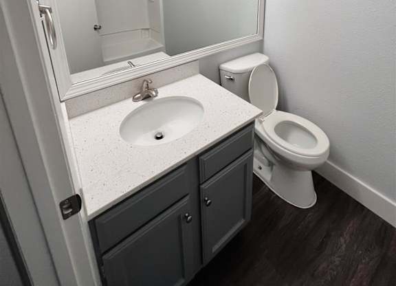 a bathroom with a sink toilet and a mirror at Northchase, Austin