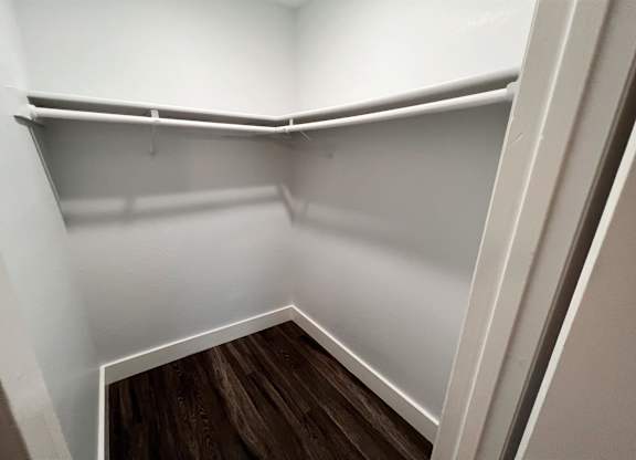 the preserve at ballantyne commons empty closet with wood floor and white walls at Northchase, Austin, TX