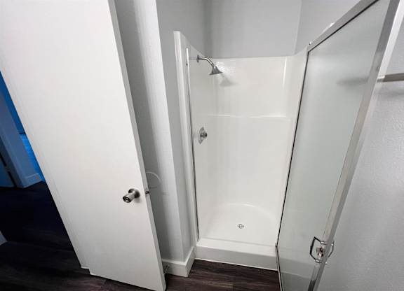 a bathroom with a shower and a sliding glass door at Northchase, Austin, TX, 78753