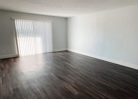 an empty living room with wood floors and a window at Northchase, Texas, 78753