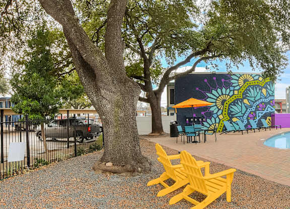 Swimming pool courtyard with covered pavilion and lounge seating at Azure Apartments, Austin, TX