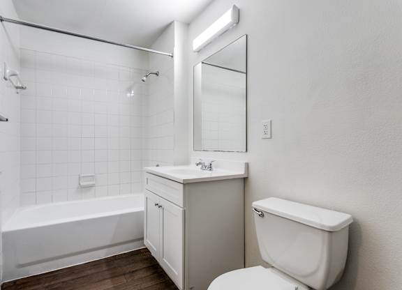 a bathroom with a toilet sink and bathtub  at Rosillo Creek Apartments, Texas