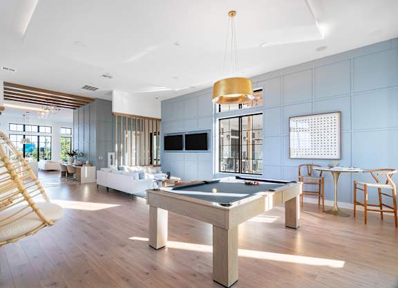Resident Clubhouse with a pool table and a chair.