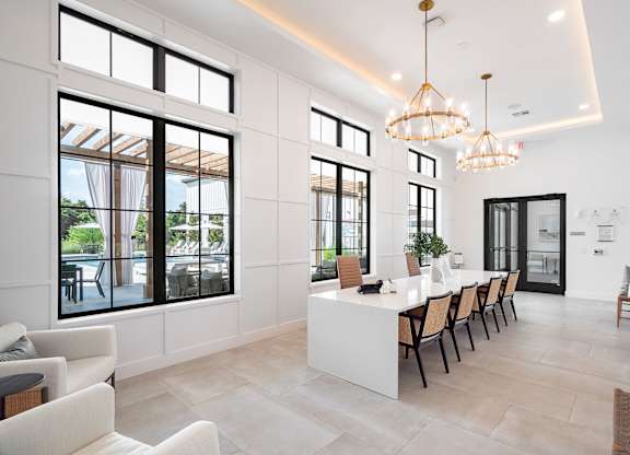 Resident Lounge with a long white table and chairs.