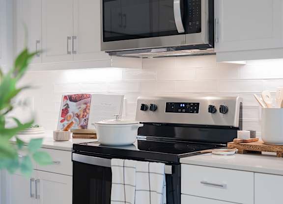 A modern kitchen with a black and white stove top.