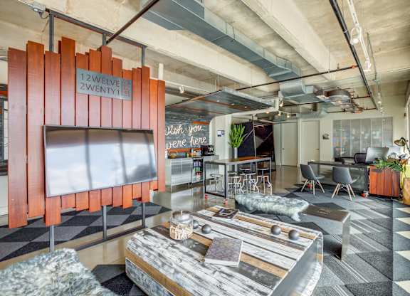 Stylish lounge area with creative workspace at 1221 Broadway Lofts Apartments, San Antonio, 78215