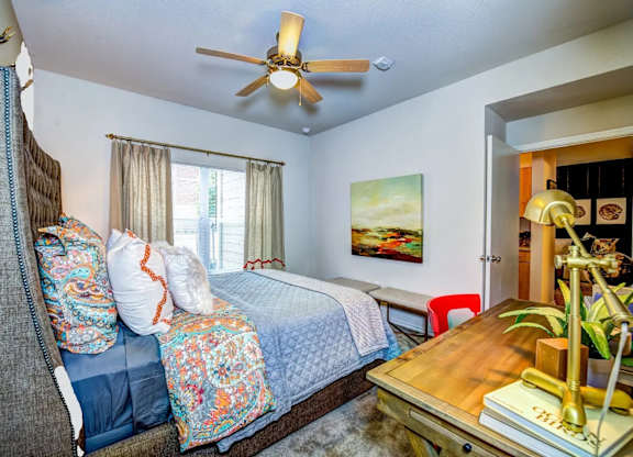 a bedroom with a bed and a ceiling fan at Villa Espada Apartments, San Antonio, TX, 78221