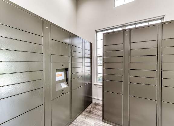 A row of stainless steel turnstiles with a card reader in the middle at Rosemary Apartments, Conroe, TX