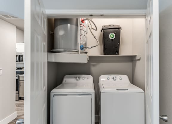 A laundry room with a washer and dryer in it at Rosemary Apartments, Conroe, TX