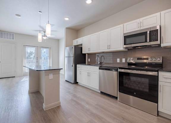 Modern kitchen with stainless steel appliances at Emilia Apartments, Boerne, TX