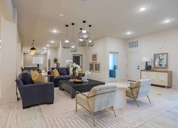 Clubhouse lounge with modern pendant lighting at Emilia Apartments, Boerne, TX