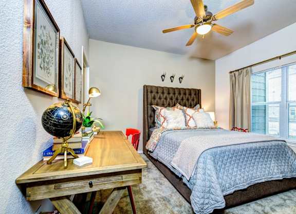 a bedroom with a bed and a ceiling fan at Villa Espada Apartments, Texas