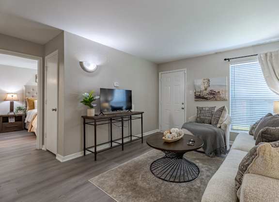 A living room with a grey couch and a coffee table.