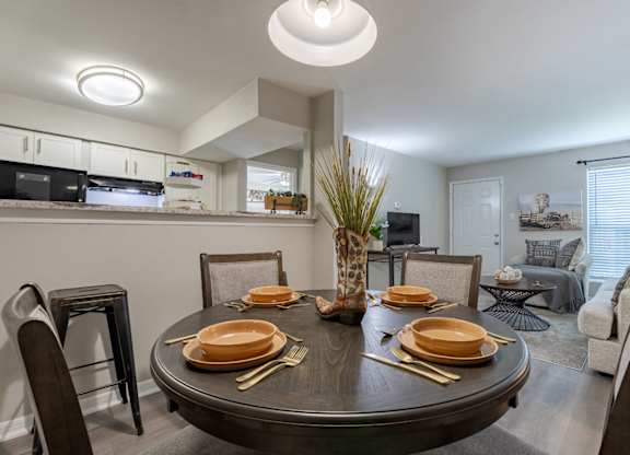 A modern dining room with a round table set for a meal.