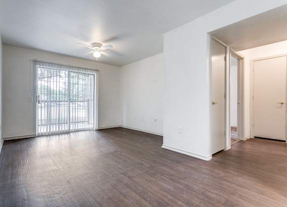 a bedroom with hardwood floors and white walls  at Rosillo Creek Apartments, San Antonio, 78218