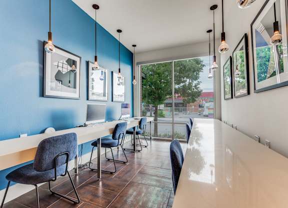 A room with blue walls and a long table with chairs.