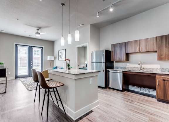 A modern kitchen with a dining table and chairs.