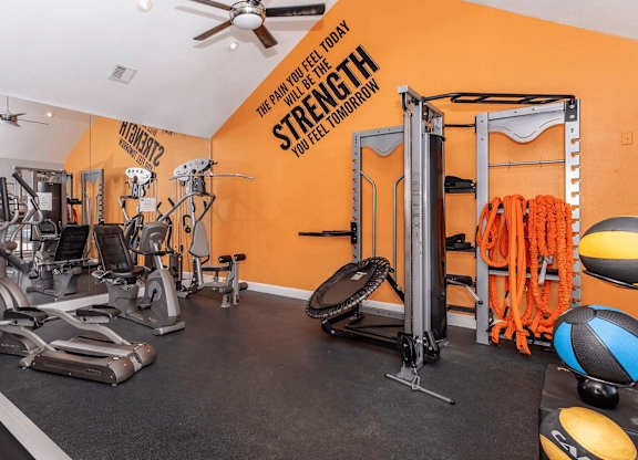 a home gym with exercise equipment and a ceiling fan at Tranquility Grove, Houston, TX 77090
