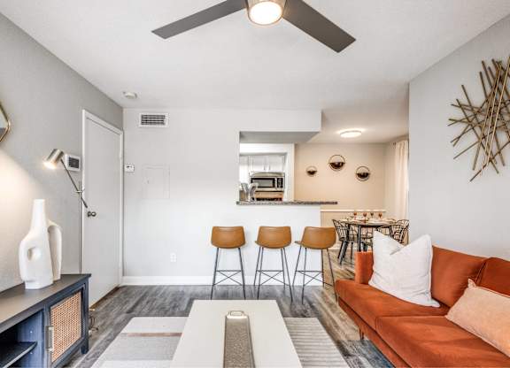 Open concept living room with modern furnishings at Monarch Medical Center Apartments, Texas
