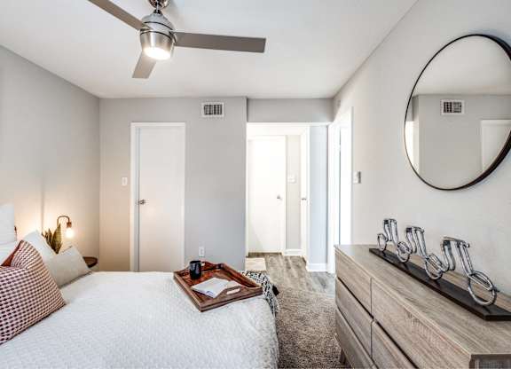 Bedroom with ceiling fan and modern furnishings at Monarch Medical Center Apartments, Texas, 77054