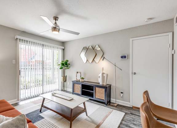 Living room with modern furniture and ceiling fan at Monarch Medical Center Apartments, Houston, TX