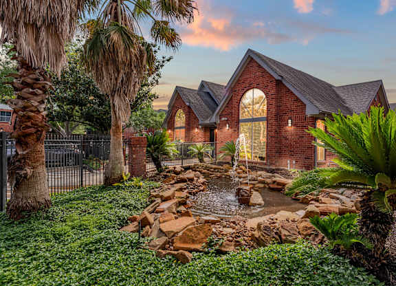 Brick exterior with water feature and landscaping at Monarch Medical Center Apartments, Houston, TX 77054