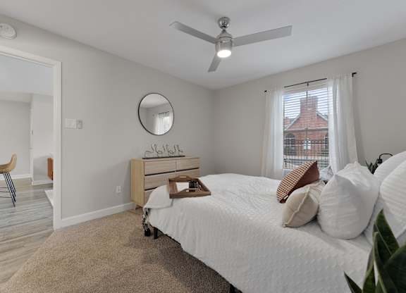 Spacious bedroom with en suite bathroom access at Monarch Medical Center Apartments, Houston, TX