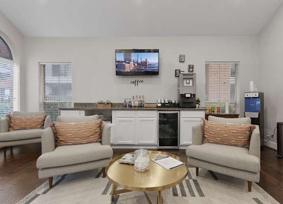 Community lounge with coffee station and seating at Monarch Medical Center Apartments, Houston, Texas