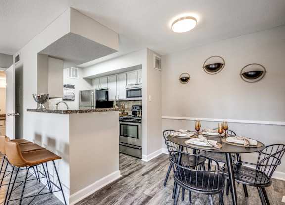 Open dining area with kitchen breakfast bar at Monarch Medical Center Apartments, Texas