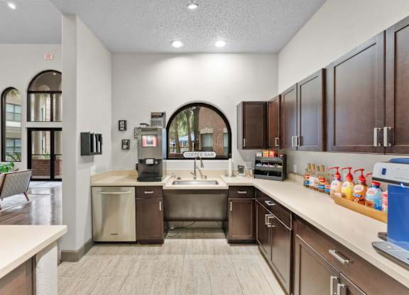 Coffee bar with dark wood cabinets and beverage station at Melia Medical Center Apartments, Houston, 77054