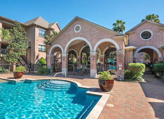 Pool deck with arched pavilion and brick details at Melia Medical Center Apartments, Texas, 77054
