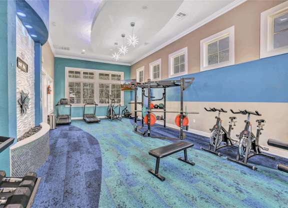 A gym with a bench, weights, and exercise bikes.